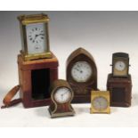 A brass carriage clock with travelling case, a miniature clock with travelling case, a gothic arched