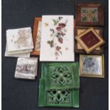 A collection of 20th century tiles, to include a Maw & Co acorn relief tile, Minton "Old King Cole",