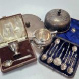 A collection of silver items including a cased set of spoons, ashtrays, cigarette case, toast