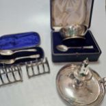 A cased silver christening bowl and spoon, a cased silver fork and spoon set and 2 silver toast