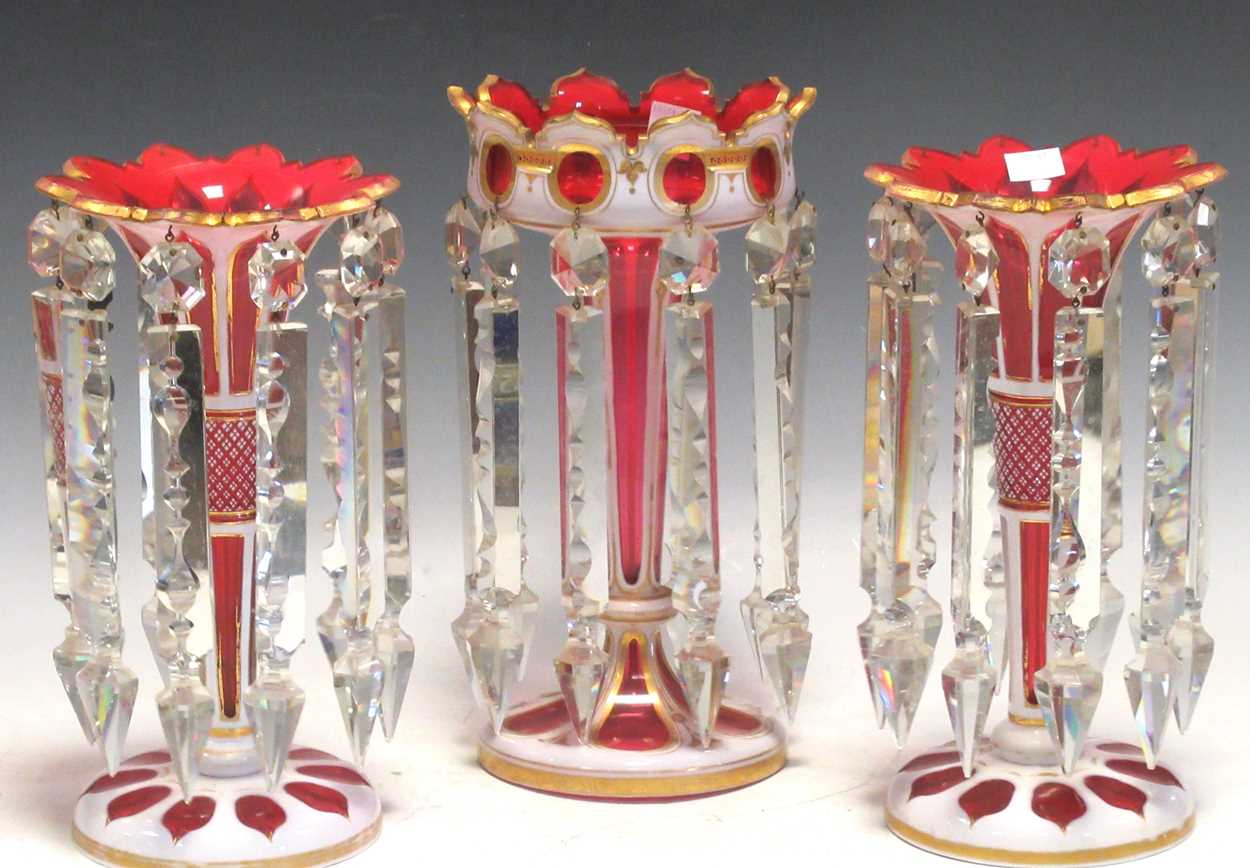 A pair of ruby flash lustres 28.5cm high and a larger single lustre 30cm high (3)Generally good