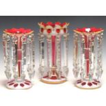 A pair of ruby flash lustres 28.5cm high and a larger single lustre 30cm high (3)Generally good