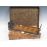 An Indian brass inlaid tray, a folding chess or draughts board (worn), parquetry shelf with hinged