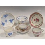 A Sevres porcelain tea cup and saucer, painted with blue floral bouquets, gilt dentil rims,