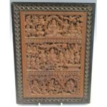 An Anglo-Indian carved sandalwood/hardwood plaque, decorated with three scenes of multi-armed gods