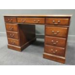 A mahogany pedestal desk with an inset red leather top, labelled 'N H Chapman & Co', 77 x 130 x