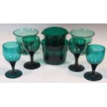 A collection of green glassware, to include a pair of glass rinsers, six wine glasses and two bowls