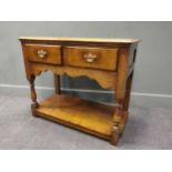 A small oak dresser with a scalloped apron on turned leg with shelf stretcher, comprising two