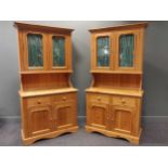A pair of pine dressers with glazed top sections above two short drawers and two cupboard doors, 213