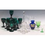 A quantity of drinking glasses, to include green glass wine glasses, faceted champagne flutes, a