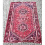 A hand-knotted red ground Qashqai carpet286 x 180cm