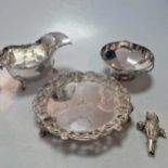 A silver sauceboat, a silver waiter, a silver dish and a silver owl rattle, 25.1ozt gross (4)Sauce