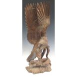 A carved wooden eagle and serpent, possibly Indonesian, 69cm high