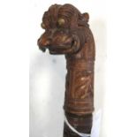 An Indian carved handle walking cane with stylised dragon head terminal, total length 97cm