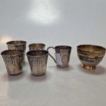 Five French metalwares silver tot cups, one with a with handle, together with Russian metalwares