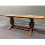 An oak refectory table raised on cup and cover legs, 213 x 75 x 85cm