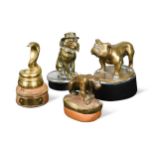 A group of four brass car mascots,