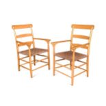 A pair of Scandinavian open armchairs with woven seats,