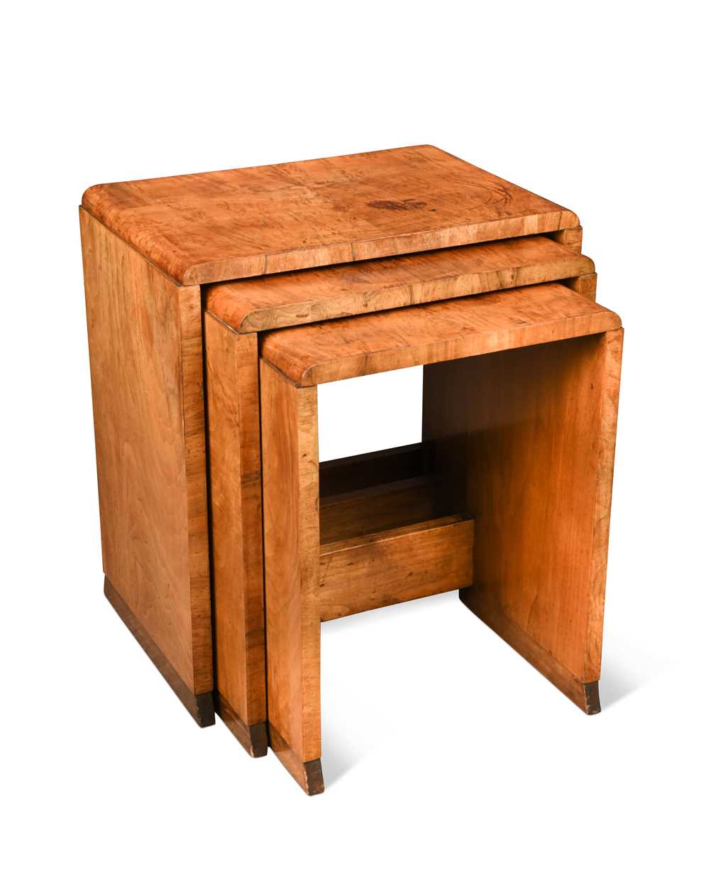 An Art Deco nest of three walnut side tables,