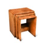 An Art Deco nest of three walnut side tables,