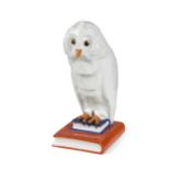A large Herend model of an owl perched on a pile of books,