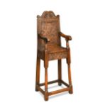 A carved oak high chair, in the 17th century style,