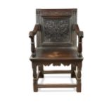 A carved oak open armchair, 17th century,