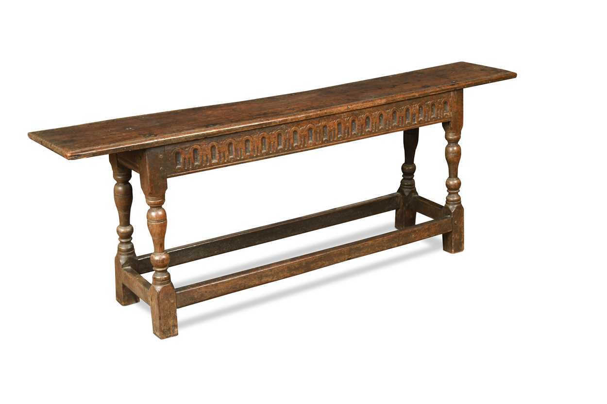 A carved oak bench, 17th century,