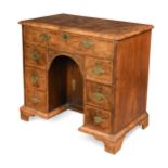 A George II walnut kneehole desk,