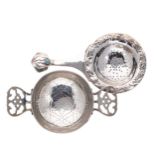 Two early 20th century silver tea strainers,