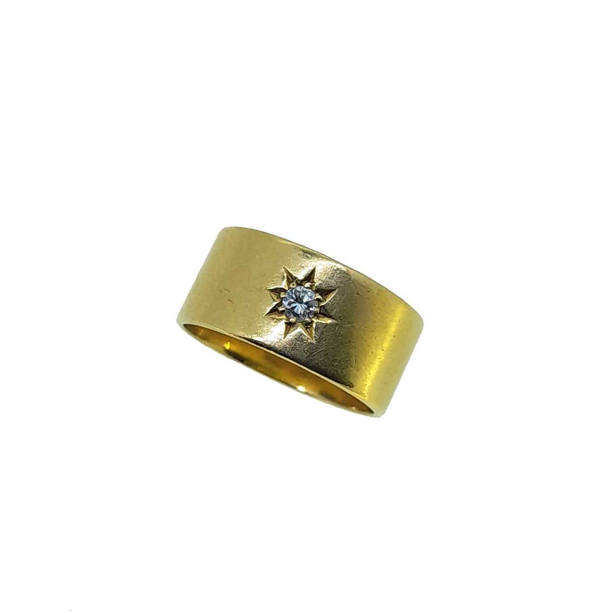 A late 20th century 18ct gold diamond set band,