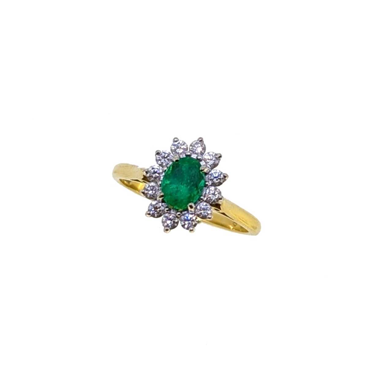 An 18ct gold emerald and diamond cluster ring,