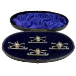 A cased set of four early 20th century silver novelty menu/place card holders,