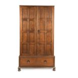 An Arts & Crafts oak wardrobe in the manner of Heal's, circa 1920,
