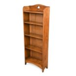 In the manner of Liberty & Co., an Arts and Crafts oak bookcase,