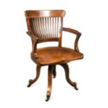 In the manner of E. W. Godwin (1833-1886) for James Peddle, a swivel desk chair, late 19th century,