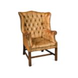 A Georgian style leather wingback armchair, 20th century,