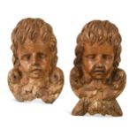 A pair of 17th century style carved wood cherubs' heads,