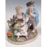 A 19th century Meissen figural group of a boy playing a wind instrument and a girl seated upon a