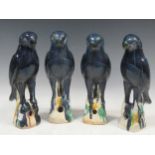 Four earthenware blue glazed birds, approx 32cm high