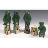 Four earthenware green glazed birds, approx 26cm high (one A/F)