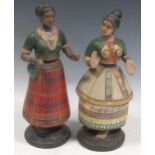 A pair of Indian painted composition articulated dancing female figures on circular stands, 29cm