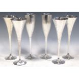A group of Culinary Concepts metal ware to include: four trumpet-shaped champagne fluted with