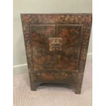 A Chinese hardwood black painted cabinet painted with a village scene, 87 x 60 x 37cm