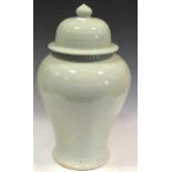 A Chinese light green glazed ceramic lidded urn, 50cm high