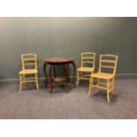 An Edwardian walnut shaped centre table 72 x 78cm, and three later painted caned seat chairs (4)