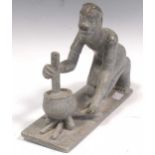 An African grey soft stone carving of a man kneeling, 20th century,