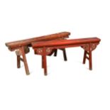 A near pair of Chinese provincial red-painted slim benches,