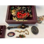 A jewellery box containing a quantity of jewellery and other items, including operculums, Georgian