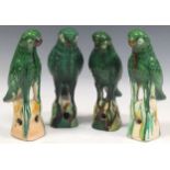 Four earthenware green glazed birds, approx 26cm high